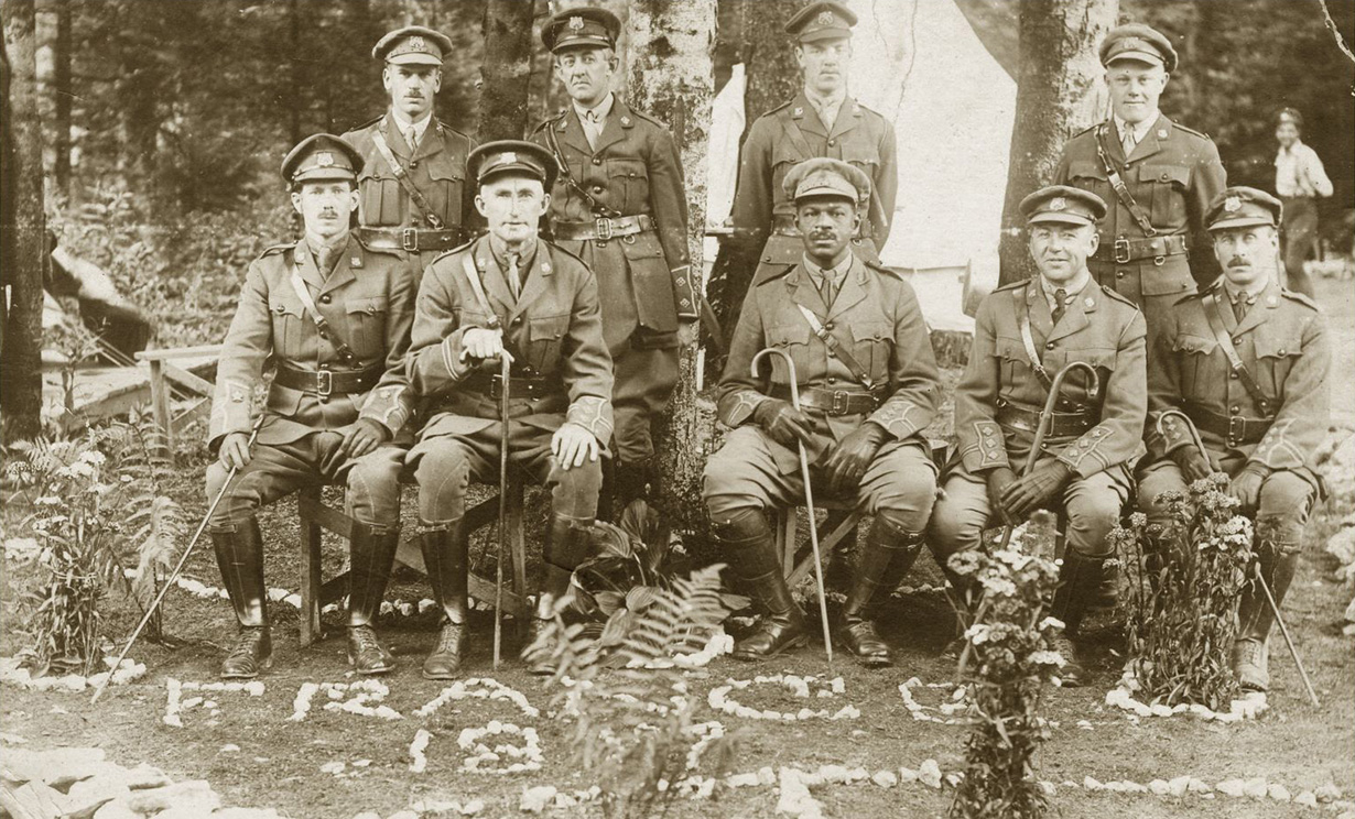 image Nine uniformed No. 2 Construction Battalion officers, Rev. Dr. W. Andrew White seated in the middle