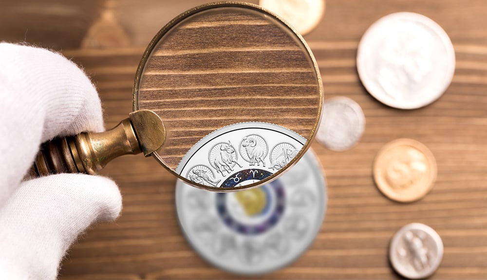 A magnifying glass. Coins are small and can be extremely detailed: a magnifying glass with at least 7x magnification will reveal all the intricacies of your favourite designs.